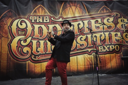 A performer onstage conducts sword swallowing.