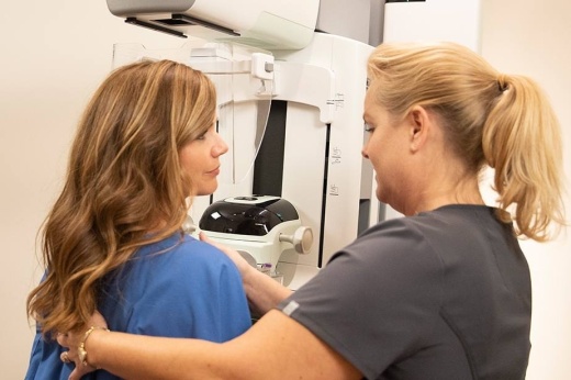 A nurse screening a woman