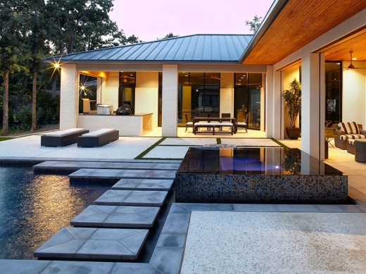 A pool outside a houses backyard.