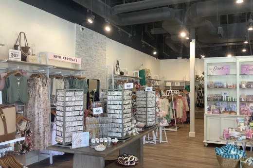 Women's apparel and jewelry displayed in the store.