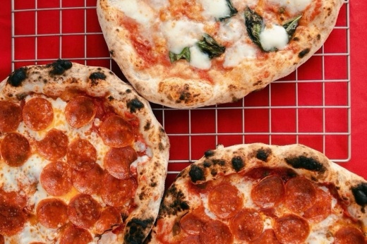 three pizzas on rack