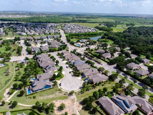 A neighborhood on a sunny afternoon in Schertz, Texas is seen via an overhead drone.