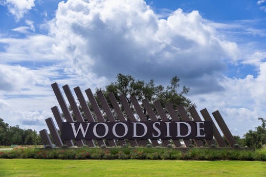 The entrance to Woodside in Georgetown is off Ronald Reagan Boulevard and Above and Beyond Way.