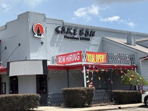 Now Open signs hang at the front of the building.