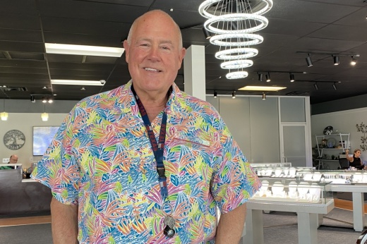 Owner George Poe stands in his store in front of cases of jewelry