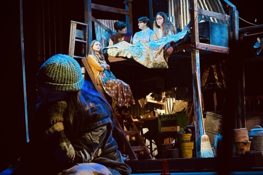 Students participate in a theatre production on stage