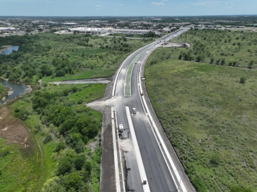 The road is shown from a drone ahead of the grand opening.