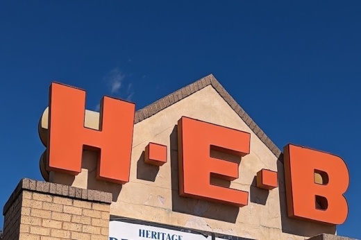 The exterior sign of a H-E-B grocery store.