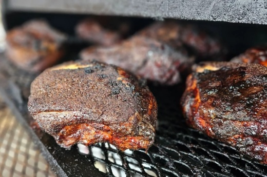The photo shows six cuts of meat being grilled.