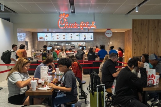 Travelers visit the new Chick-fil-A concession July 30 in Terminal E at IAH, which opened as part of a $1.5 billion airport redevelopment. (Courtesy Houston Airports)