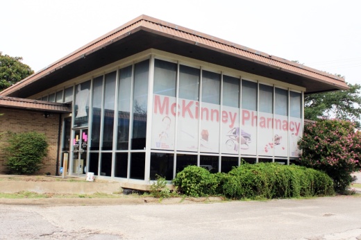 Exterior of a building with ground to roof window featuring McKinney Pharmacy signage.