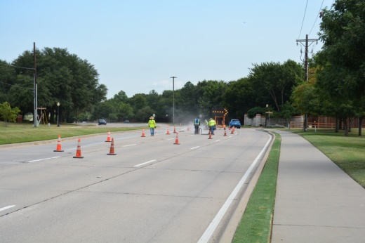Work crews make pavement joint seal repairs on Gerault Road, which turns into Morriss Road.
