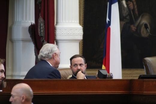 Texas House Speaker Dustin Burrows, right, speaks with Rep. Drew Darby, R-San Angelo, on the House dais Aug. 20. (Hannah Norton/Community Impact)