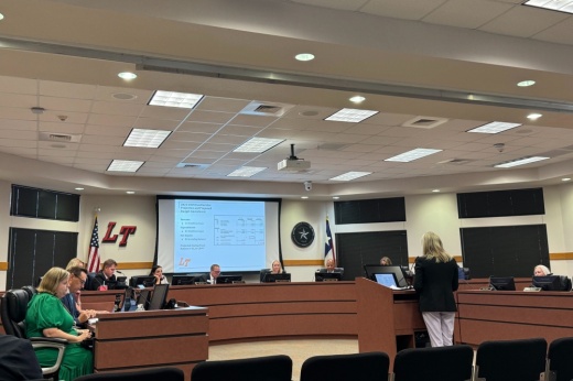 LTISD board of trustees on dais, CFO Pam Sanchez at the podium