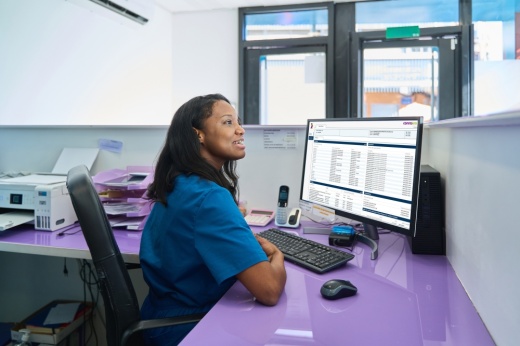 A woman sits at a computer
