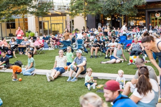 People at sit on a lawn