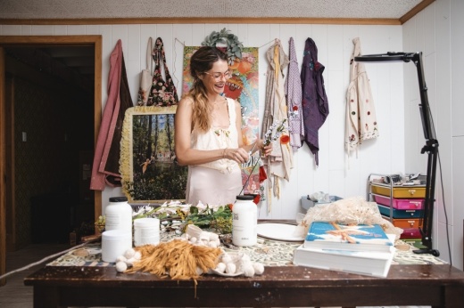 an artist holds flowers