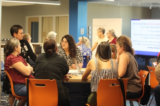 People sit around a table and talk