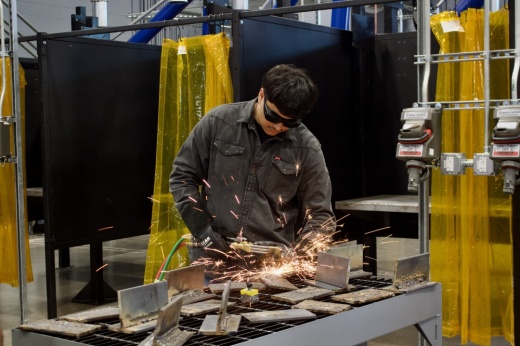 Juan Uvalle, an 11th grader from Lewisville High School, gives a welding demonstration. (Mary Katherine Shapiro/Community Impact)