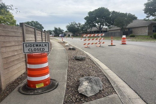 A sidewalk closed sign is seen next to roadwork in Cibolo, Texas.