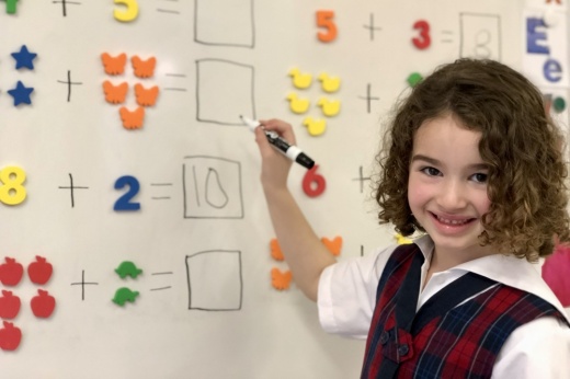 a student writes on a white board
