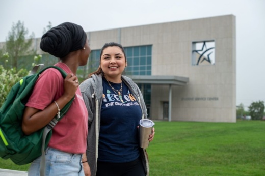 two girls walking on a college campus