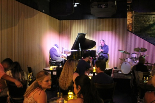 Two people perform on a stage