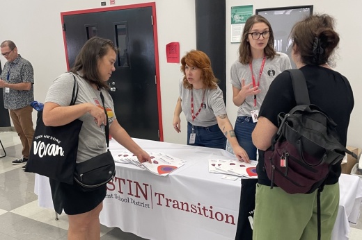 People talk to parents at a table