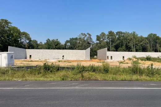 ArchPoint building with gray brick walls under construction.