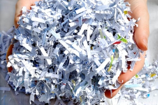 a hand holding shredded paper