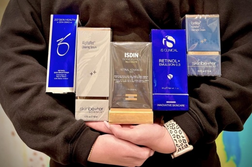 Woman holding packages of retinol