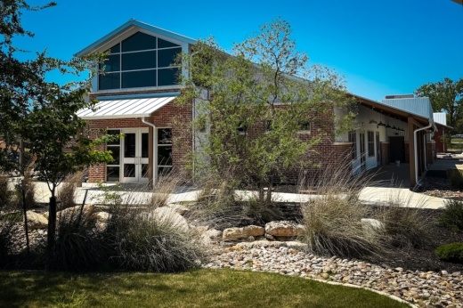 The exterior of a new, large multipurpose building.
