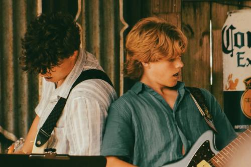 two boys play guitar