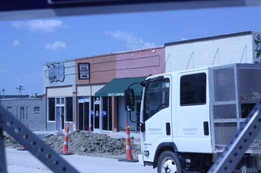 road construction is seen in front of storefronts in a downtown area