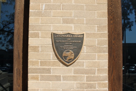 Pictured is the historic building plaque on the Hays County Historic Courthouse.