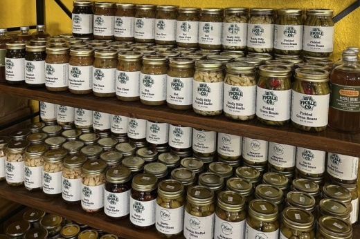 A photo of a row of pickles in a can.