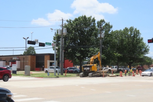 a road intersection with construction happening in the distance