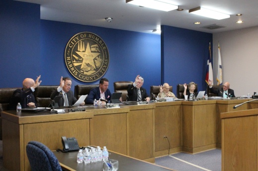 Humble City council raising hands to vote