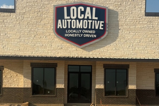 Pictured is a building with a sign that says Local Automotive.
