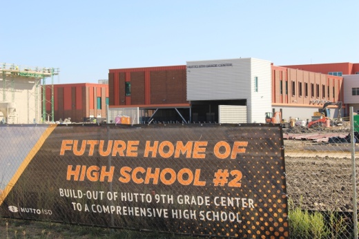 a sign on a fence for a future high school