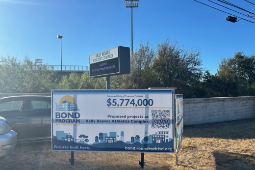 a banner on a fence outside an athletic field