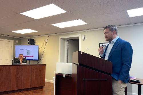man speaks at a podium