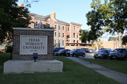 A Texas Woman's University sign at a campus entrance