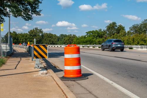 an orange road barrier on the side of the road