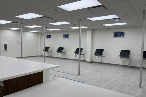 Election voting machines are seen in a white-painted room in Schertz, Texas.