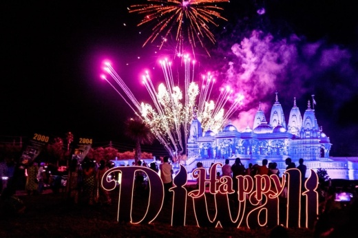 diwali celebration with pink and blue fireworks at nighttime