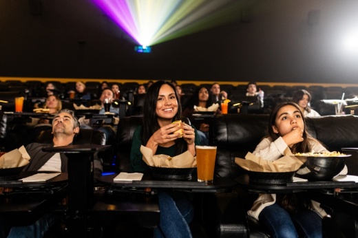 Guests enjoying handcrafted food, craft beer, and blockbuster movies at Flix Brewhouse Frisco, a Texas-born dine-in movie theater and brewery offering a full-service cinematic dining experience with recliner seating, in-theater service, and locally brewed beer.
