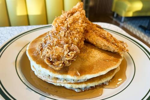 a plate with pancakes and fried chicken