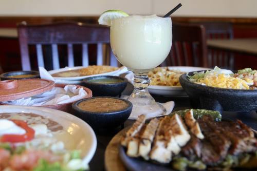 The bar menu includes the Ultimate Margarita made with Hornitos Reposado Tequila, Jalisco orange triple sec and fresh lime juice ($9 for 10oz or $13 for 20oz). (Katlynn Fox/Community Impact)