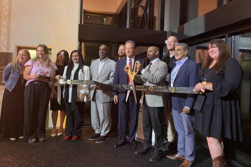 Children's Emergency Relief International team members joined with city of Austin officials to cut the ribbon for the grand opening of the global headquarters. (Sienna Wight/Community Impact)